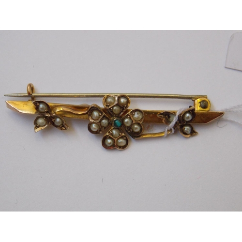 413 - THREE 9 CARAT GOLD BROOCHES TO INCLUDE A RUBY, GREEN SHAMROCK AND A SEA PEARL