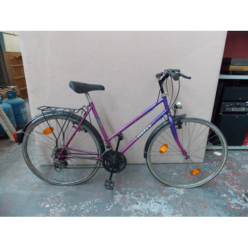 7 - A PURPLE CLIPPER LADIES TOWN BIKE WITH DYNAMO LIGHTS AND 18 SPEED INDEX GEAR SYSTEM