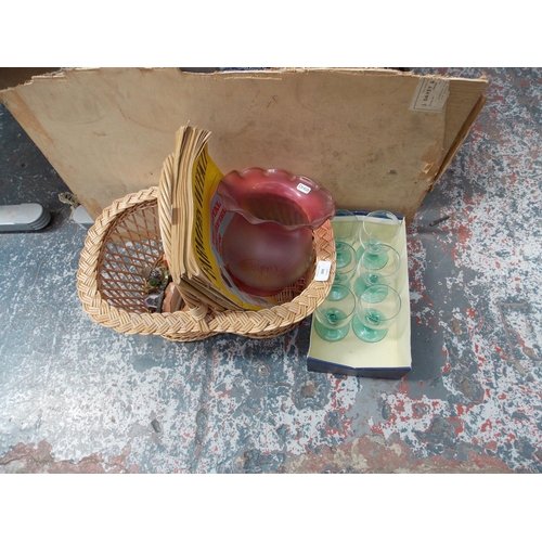 242 - A WICKER BASKET CONTAINING 1969 FARMERS WEEKLY MAGAZINES AND GLASSWARE