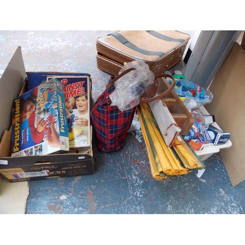 253 - TWO BOXES AND A BAG CONTAINING GAMES, LIGHT BULBS, CLEANING EQUIPMENT, MINIATURE IRONING BOARD ETC