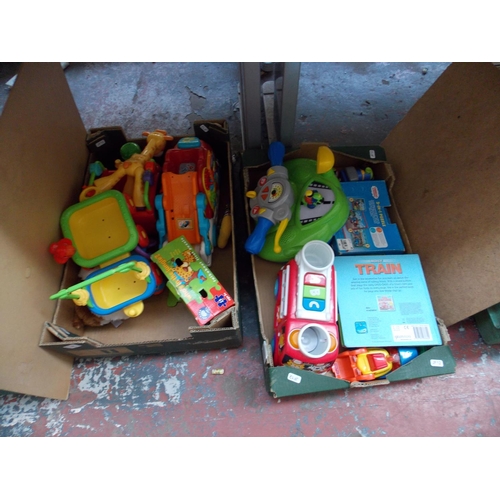 264 - TWO BOXES OF TOYS TO INCLUDE PUZZLES, TRAIN, GIRAFFES, MOTORBIKE STEERING ETC