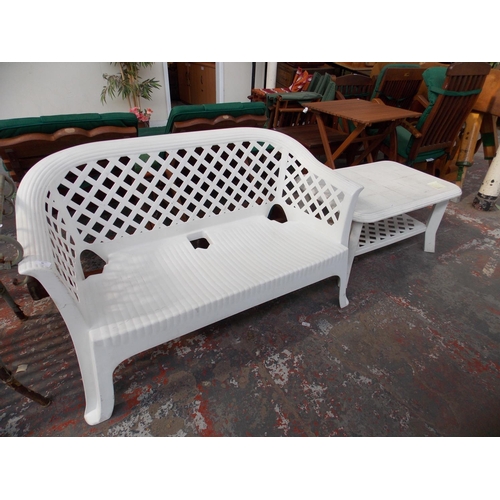 30 - TWO ITEMS TO INCLUDE A WHITE PLASTIC TWO SEAT GARDEN BENCH AND A MATCHING TABLE