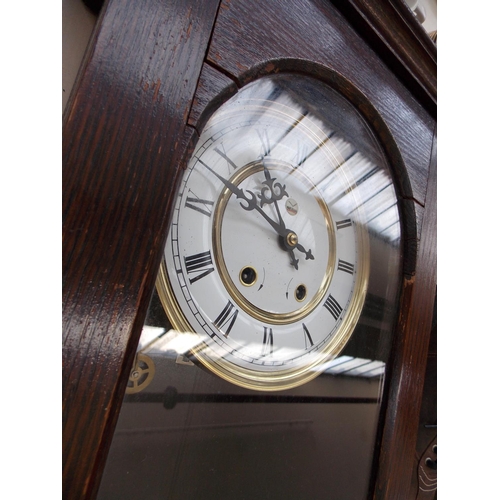 312 - A LARGE OAK WALL HANGING CLOCK