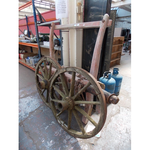 42 - AN ANTIQUE HAY CART WOODEN SWIVEL FRONT AXLE AND TWO WHEELS