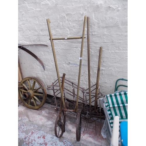 82 - A MIXED LOT OF VINTAGE ITEMS TO INCLUDE AXE HAY FORKS, HORSE DRAWN HARROW ETC