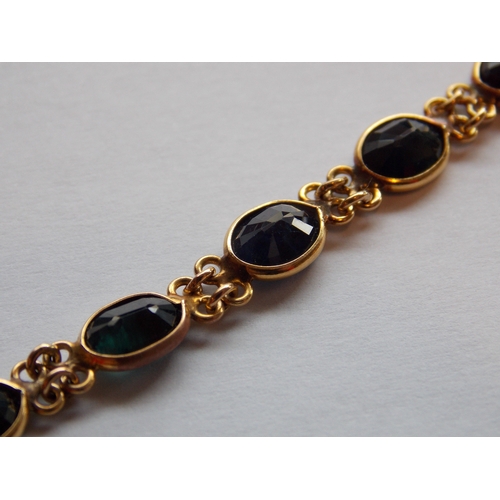 489 - A 15 CARAT GOLD SAPPHIRE 8 INCH BRACELET (TESTED BY VENDOR)