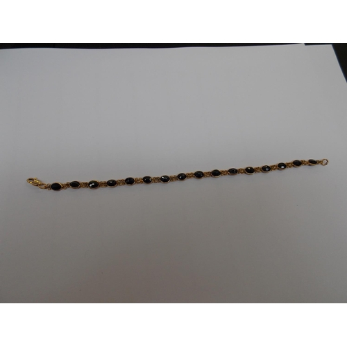 489 - A 15 CARAT GOLD SAPPHIRE 8 INCH BRACELET (TESTED BY VENDOR)