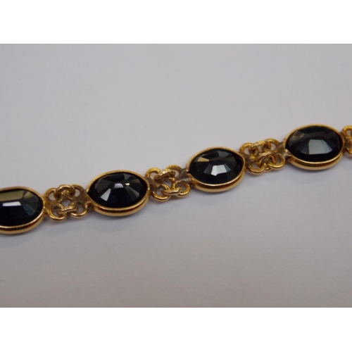 489 - A 15 CARAT GOLD SAPPHIRE 8 INCH BRACELET (TESTED BY VENDOR)