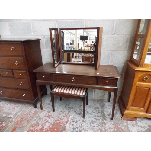 535 - A STAG MAHOGANY DRESSING TABLE WITH THREE DRAWERS, THREE SECTIONED MIRROR AND A DRESSING TABLE STOOL