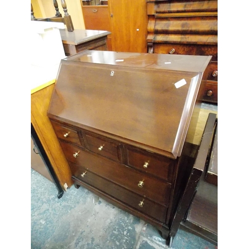 563 - A STAG MAHOGANY BUREAU WITH FIVE DRAWERS AND A FALL FRONT