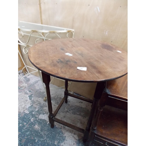 566 - A WROUGHT IRON GLASS TOPPED HALL TABLE AND A ROUND MAHOGANY TABLE