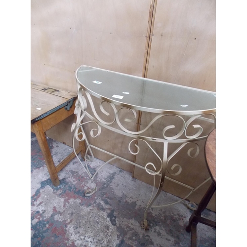 566 - A WROUGHT IRON GLASS TOPPED HALL TABLE AND A ROUND MAHOGANY TABLE