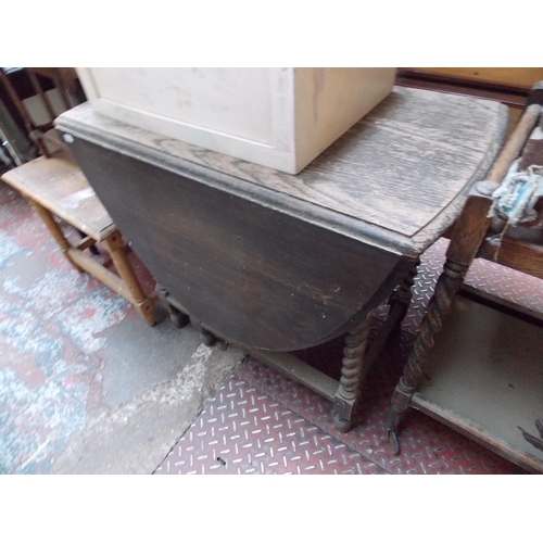 573 - AN OAK DROP LEAF TABLE AND A WHITE MEDICAL CABINET