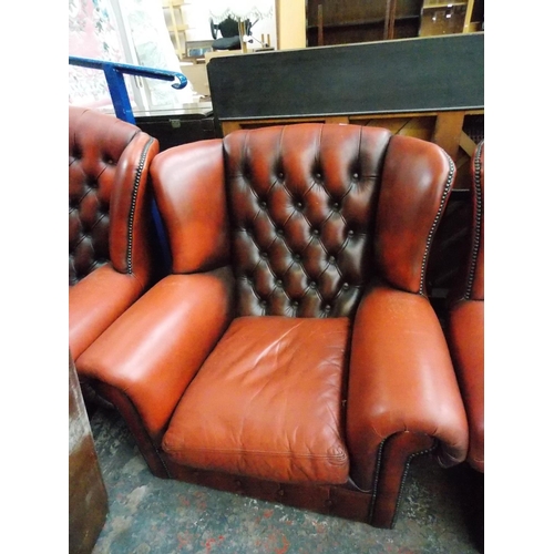 618 - AN OXBLOOD CHESTERFIELD SOFA AND TWO MATCHING ARMCHAIRS