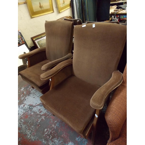 665 - A PAIR OF BROWN UPHOLSTERED ARM CHAIRS