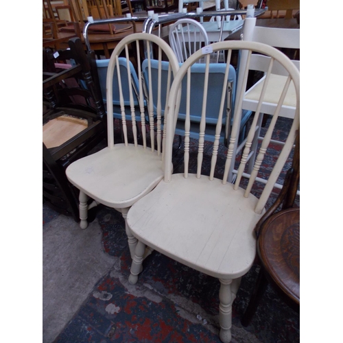 671 - A PAIR OF CREAM PAINTED KITCHEN CHAIRS