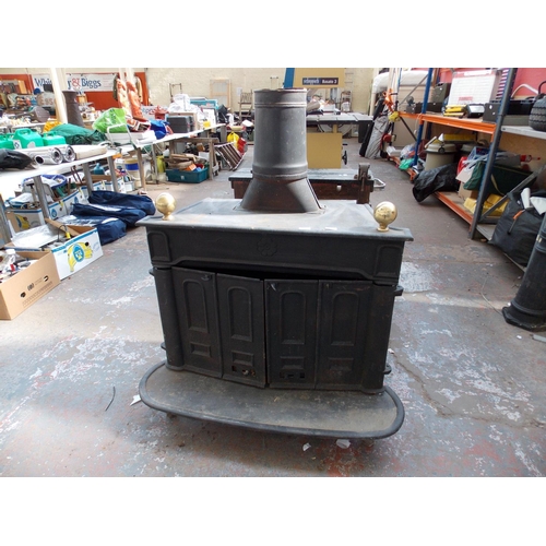 116 - A LARGE MULTI-FUEL STOVE WITH ALL FITTINGS AND PIPE