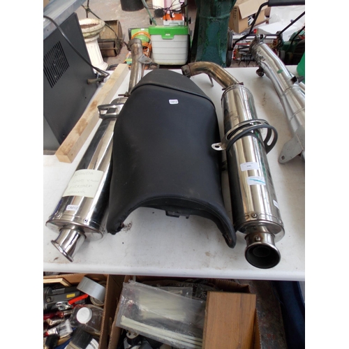 141 - THREE ITEMS TO INCLUDE A PAIR OF STAINLESS STEEL HONDA 1000 V TWIN FIRESTORM EXHAUSTS AND A SEAT