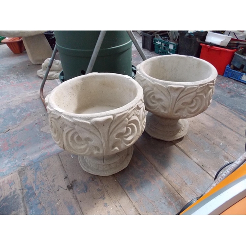 156 - A PAIR OF RECONSTITUTED STONE LEAF DESIGN PEDESTAL GARDEN PLANTERS