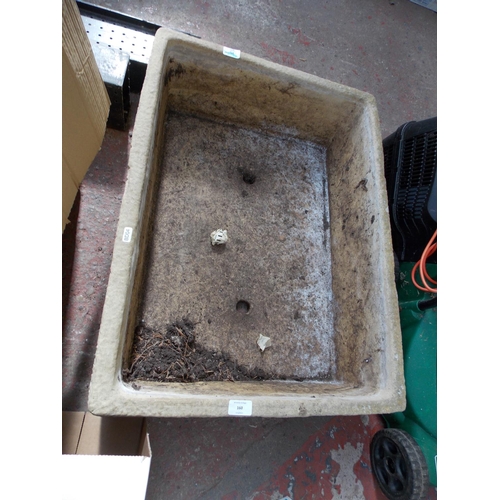 160 - A LARGE RECTANGULAR TEXTURED CONCRETE GARDEN PLANTER