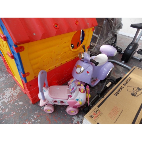 31 - THREE ITEMS TO INCLUDE A RED, BLUE AND YELLOW PLASTIC CHILDS PLAYHOUSE, A PURPLE RIDE ON THREE WHEEL... 