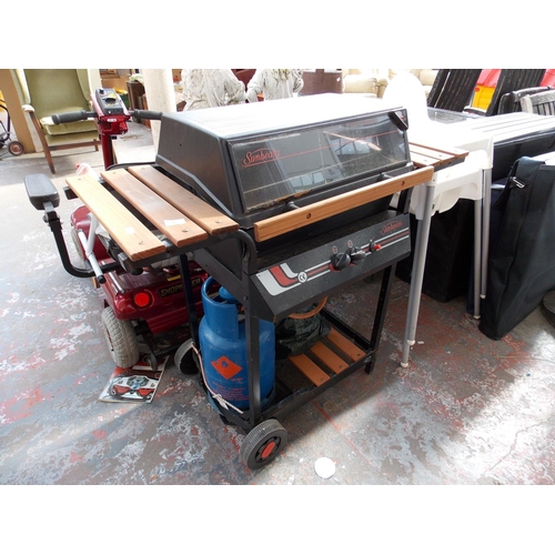 38 - A BLACK SUNBEAM GAS BARBECUE WITH SLATED TABLES AND GAS BOTTLE