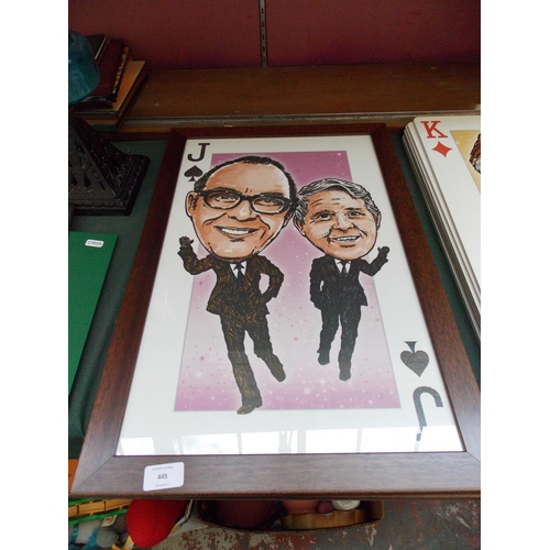 445 - TWO LARGE FRAMED PLAYING CARDS TO INCLUDE MORECAMBE AND WISE AND LES DAWSON