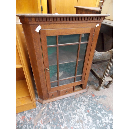 574 - AN OAK CORNER CABINET