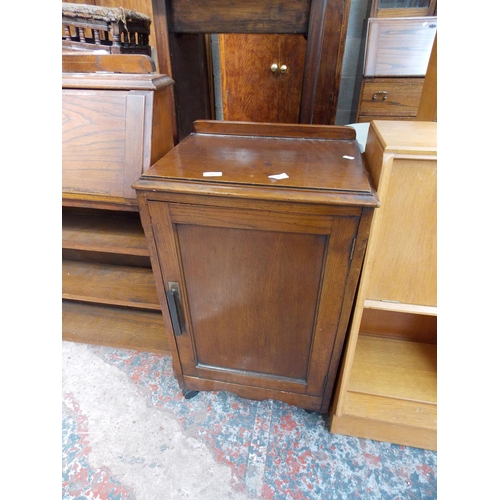 576 - A DARK OAK ONE DOOR CABINET