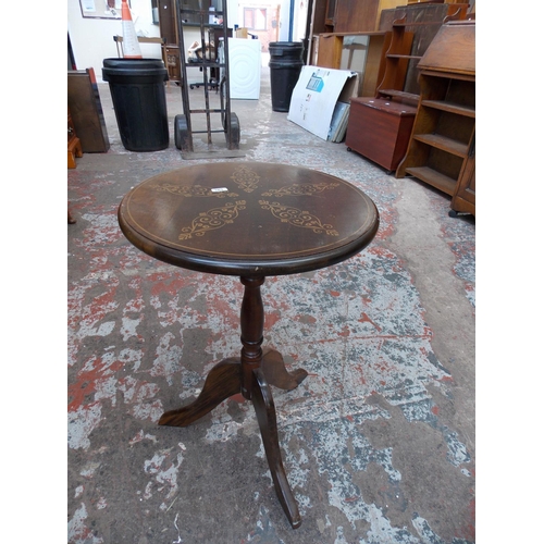 585 - A STONE COFFEE TABLE AND A MAHOGANY TRIPOD TABLE