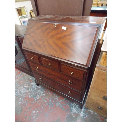 591 - A MAHOGANY BUREAU WITH FIVE DRAWERS AND A FALL FRONT