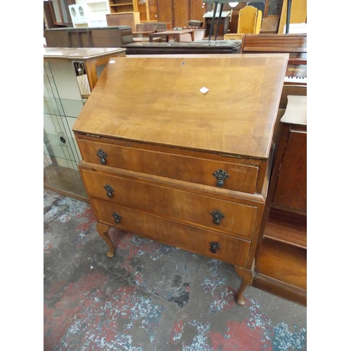 638 - A MAHOGANY BUREAU WITH THREE DRAWERS