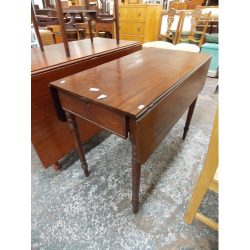 644 - A MAHOGANY DROP LEAF DINING TABLE