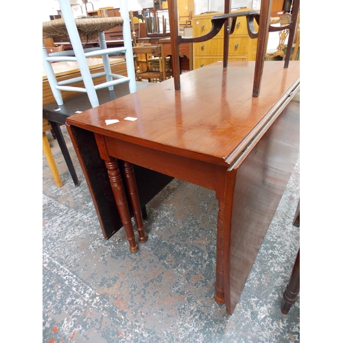 645 - A LARGE MAHOGANY DROP LEAF DINING TABLE AND A SMALL OCCASIONAL TABLE