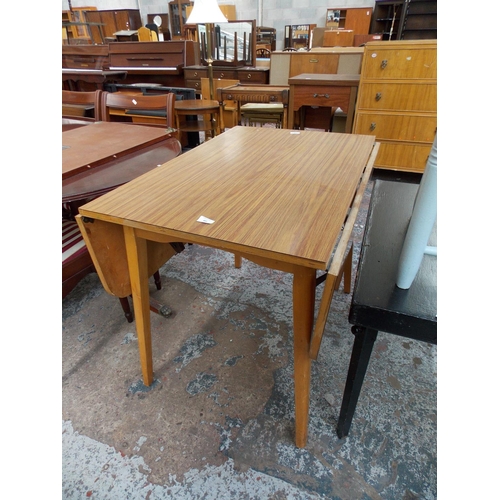 647 - A MAHOGANY EFFECT DROP LEAF DINING TABLE