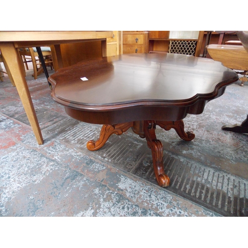 651 - A MAHOGANY SERPENTINE TOPPED COFFEE TABLE