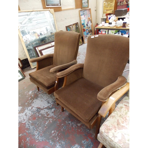 665 - A PAIR OF BROWN UPHOLSTERED ARM CHAIRS