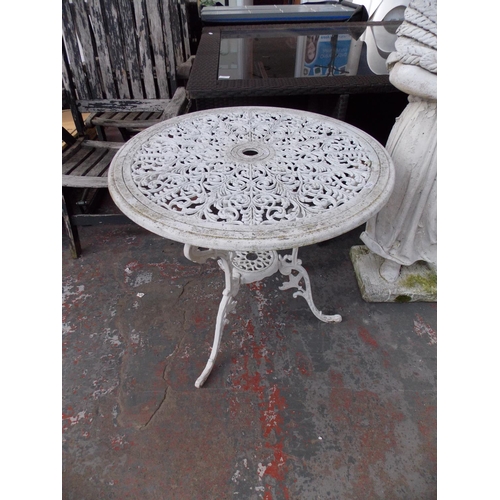 35 - TWO ITEMS TO INCLUDE A CAST ALUMINIUM CIRCULAR ORNATE GARDEN TABLE AND SHOP STEP