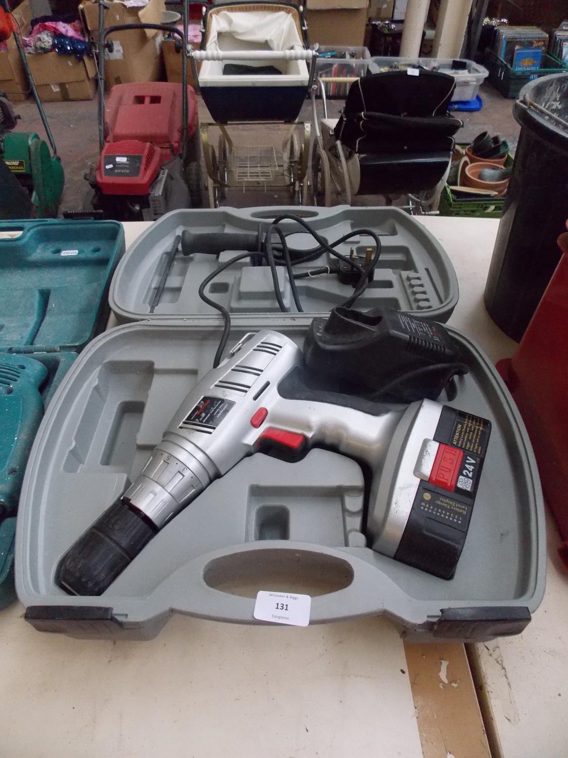 A CASED WOOLWORTHS WORKSHOP 24V CORDLESS DRILL AND CHARGER