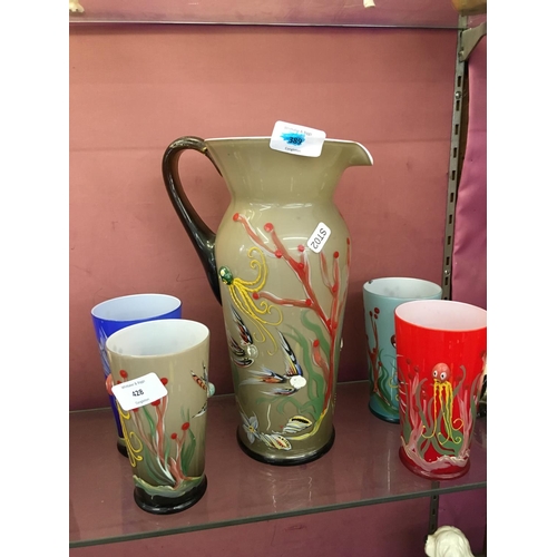 330 - A MULTI COLOURED GLASS JUG AND FOUR MULTI COLOURED GLASSES