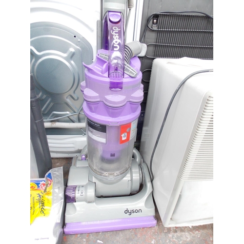 214 - A PURPLE AND GREY DYSON UPRIGHT BAGLESS VACUUM CLEANER IN W/O