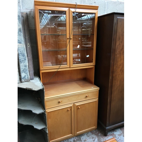 544 - A LIGHT MAHOGANY DISPLAY CABINET WITH TWO GLASS DOORS, ONE DRAWER AND TWO LOWER DOORS