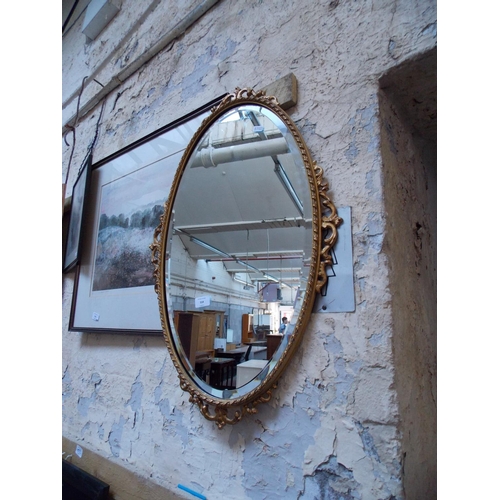 514 - AN OVAL BEVEL EDGED MIRROR