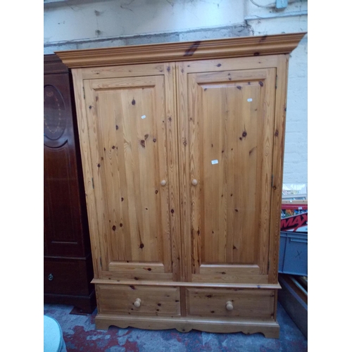 536 - A LARGE MODERN PINE DOUBLE DOOR WARDROBE WITH TWO LOWER DRAWERS