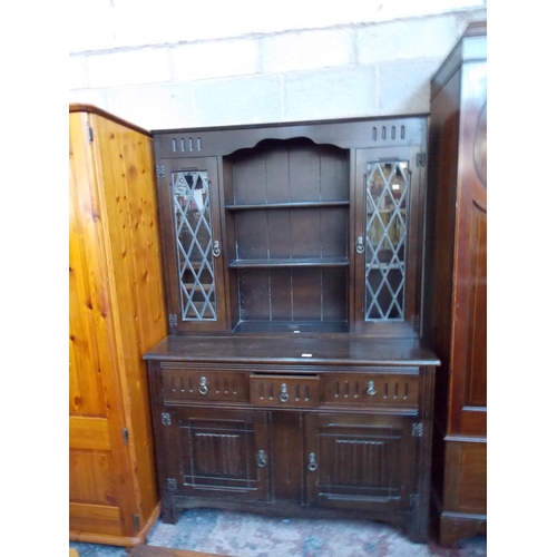 538 - AN OAK PRIORY STYLE DRESSER WITH UPPER TWO LEADED GLASS DOORS, TWO SHELVES, THREE LOWER DRAWERS AND ... 