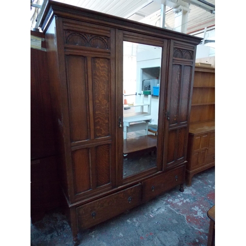 551 - A GOOD QUALITY 1930'S WARING & GILLOW DARK OAK TRIPLE WARDROBE WITH CENTRE BEVELLED EDGE MIRROR AND ... 