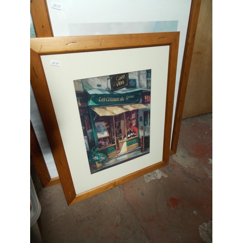 534 - FOUR ITEMS TO INCLUDE A PINE FRAMED PRINT OF A WINE SHOP, A PAIR OF FRAMED EUROPEAN PRINTS AND A MOD... 