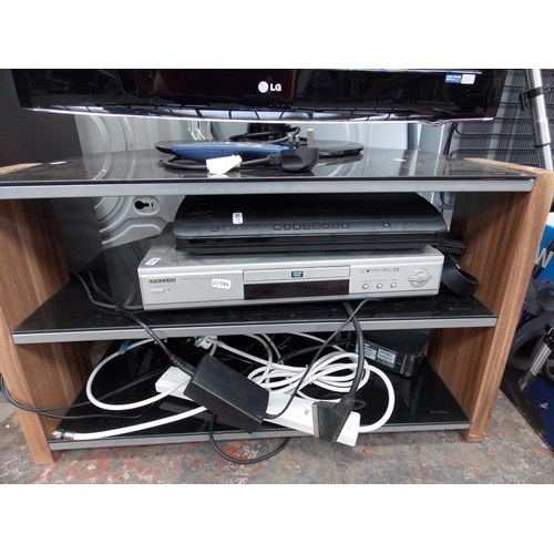 124 - A MODERN GLASS AND WOOD EFFECT TV CABINET CONTAINING VIRGIN MEDIA SET TOP BOX, SAMSUNG DVD PLAYER AN... 