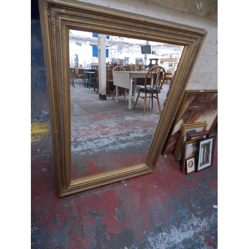 273 - A LARGE GILDED FRAMED MIRROR AND AN OIL ON CANVAS OF A CHURCH SCENE BY ARNOLD TAYLOR 1970