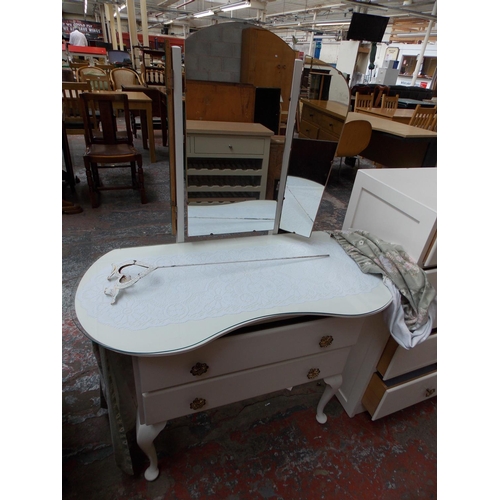 355 - A WHITE PAINTED CHEST OF FIVE DRAWERS AND A MATCHING KIDNEY SHAPED DRESSING TABLE